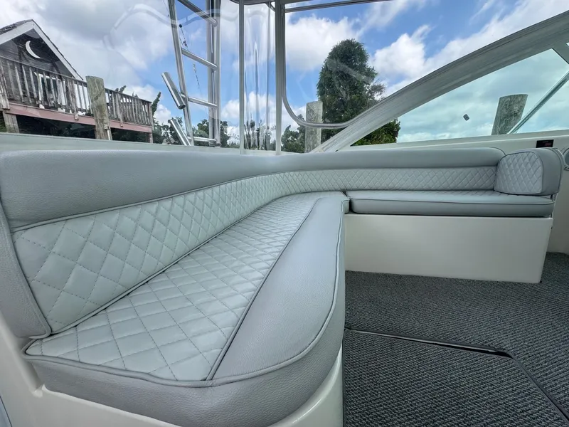 Slide: The Image of Luxurious interior seating of 2005 Cabo 40 Hardtop Express boat, featuring quilted upholstery. - 16