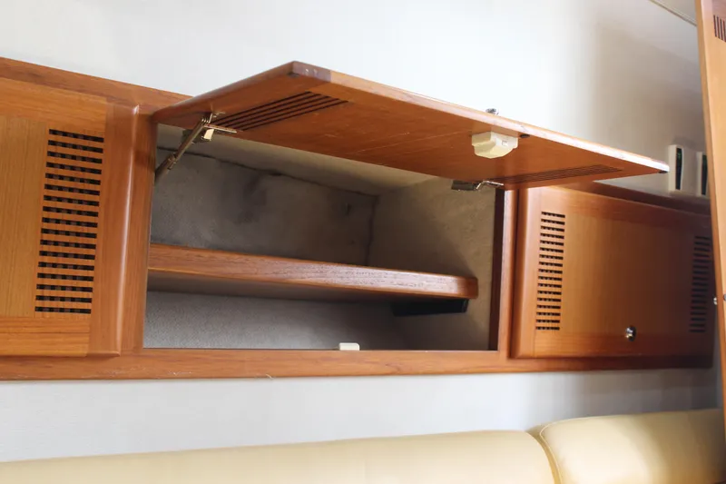 Slide: The Image of Open wooden cabinet in 2005 Cabo 40 Hardtop Express boat interior. - 19