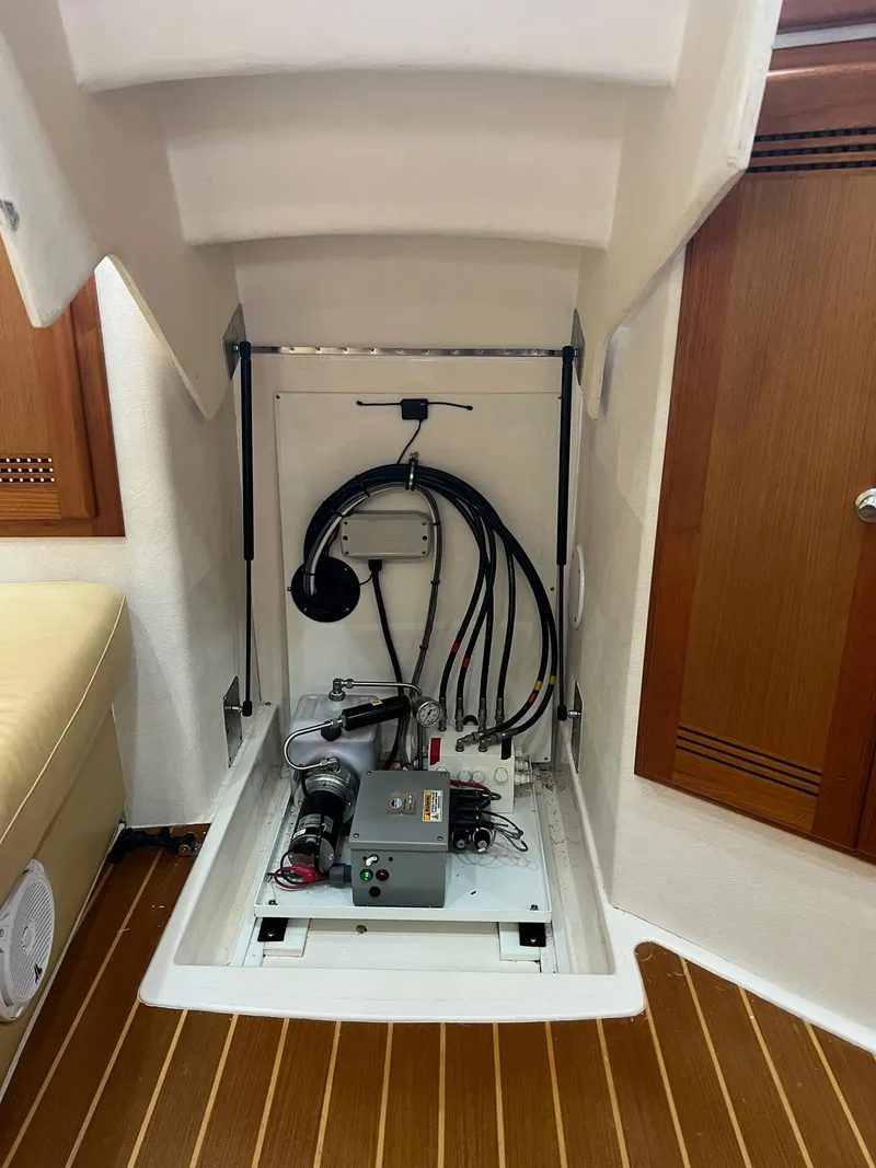 Slide: The Image of 2005 Cabo 40 Hardtop Express interior compartment with wiring and equipment. - 20