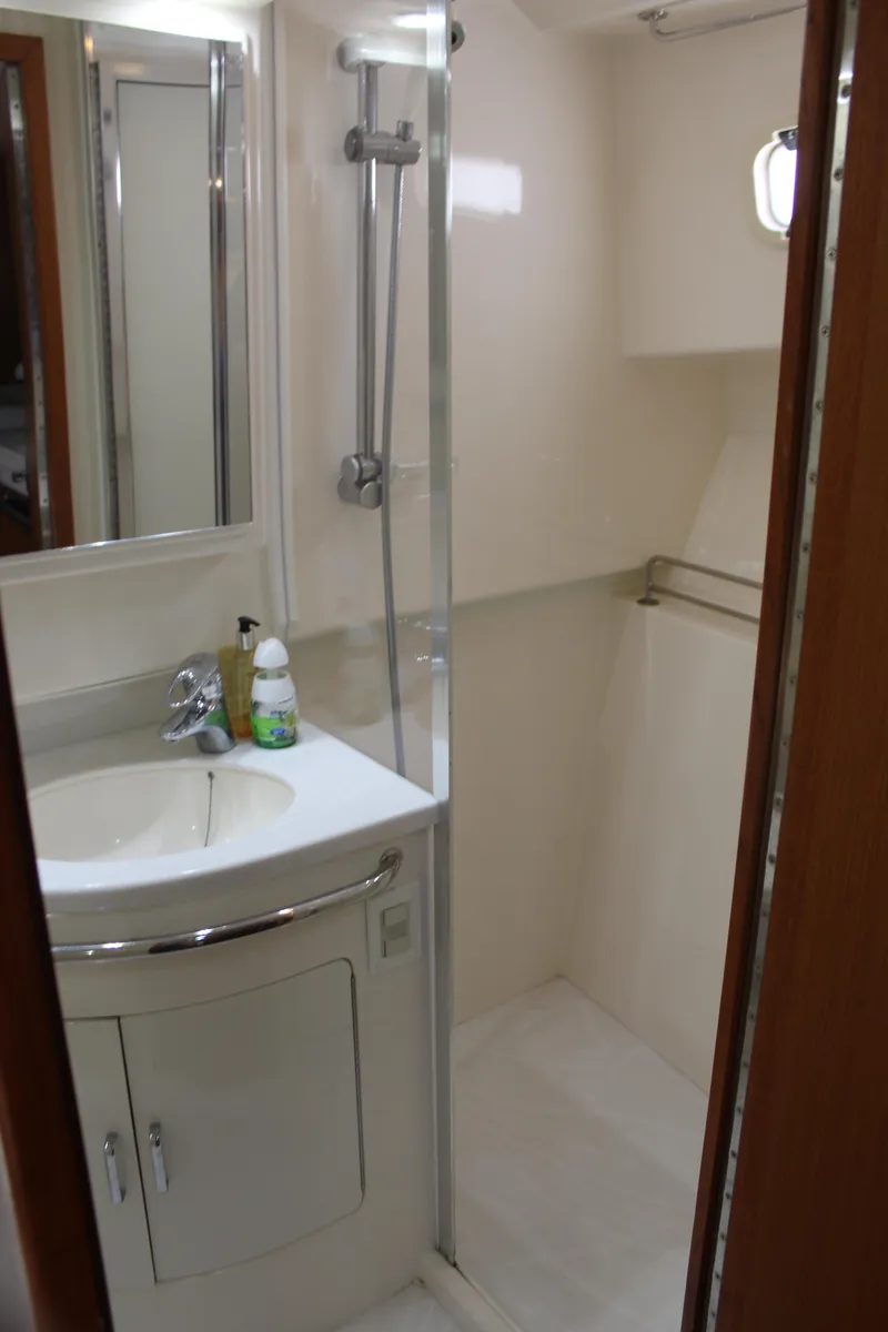 Slide: The Image of 2005 Cabo 40 Hardtop Express bathroom with shower, sink, and mirror. - 23