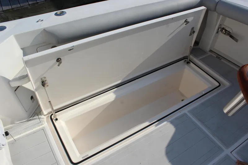Slide: The Image of Open storage compartment on a 2005 Cabo 40 Hardtop Express boat deck. - 27