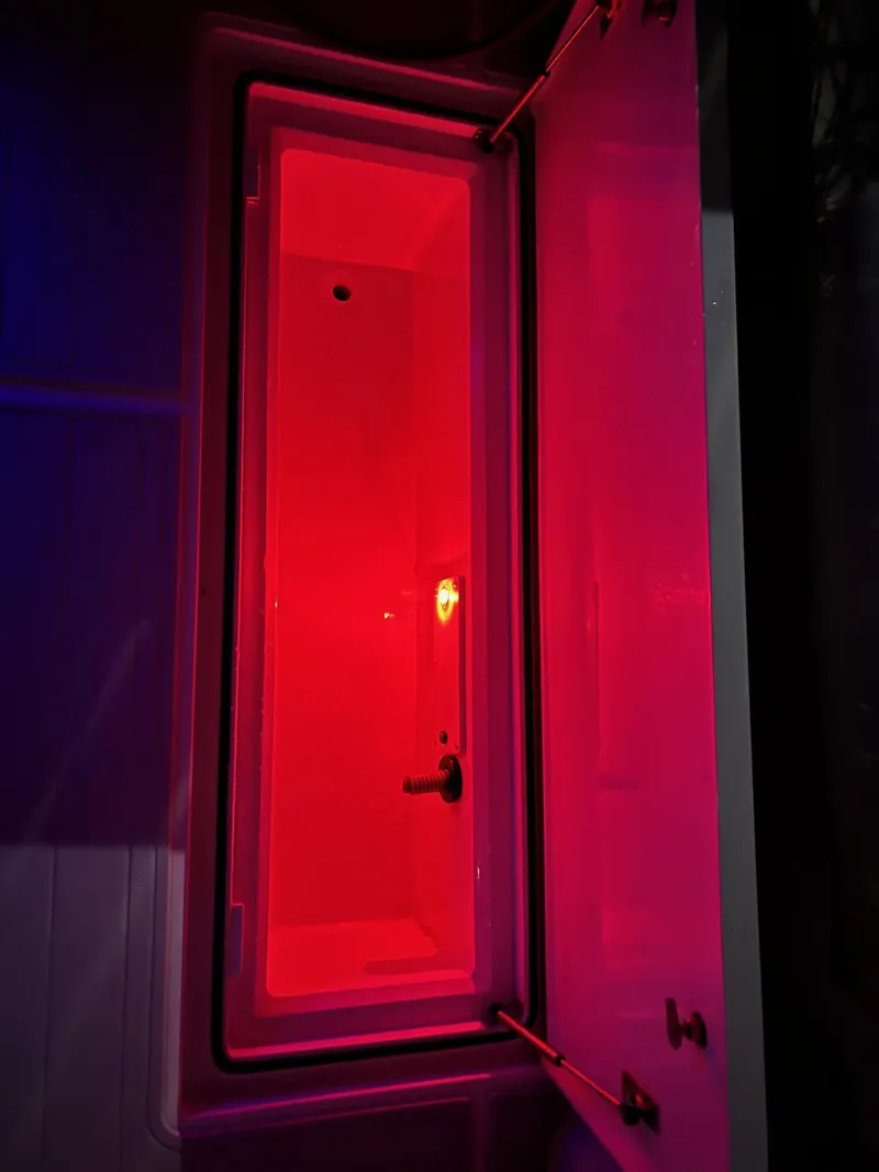 Slide: The Image of Red-lit compartment inside a 2005 Cabo 40 Hardtop Express boat. - 28
