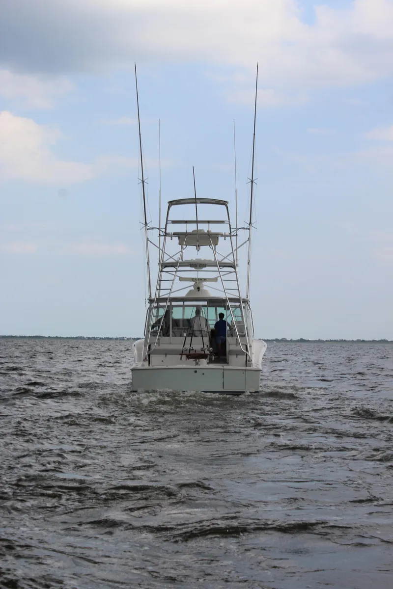 Slide: The Image of 2005 Cabo 40 Hardtop Express boat on open water under cloudy sky. - 3