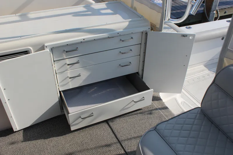 Slide: The Image of Open storage cabinet with drawers on a 2005 Cabo 40 Hardtop Express boat. - 31