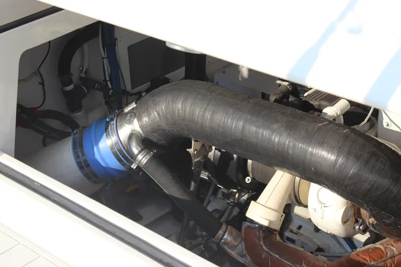 Slide: The Image of Engine compartment of a 2005 Cabo 40 Hardtop Express boat, showing hoses and components. - 34