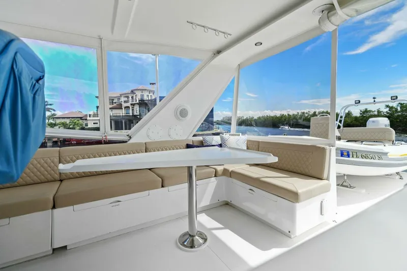 Slide: The Image of Luxurious boat interior with beige seating, table, and scenic waterfront view. - 11