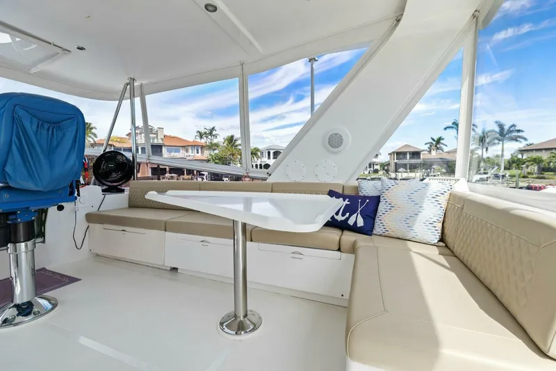 Slide: The Image of Luxurious yacht interior with beige seating, table, and scenic marina view. - 12