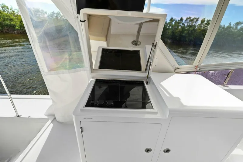 Slide: The Image of Boat kitchen area with stove, open hatch, and river view. - 17