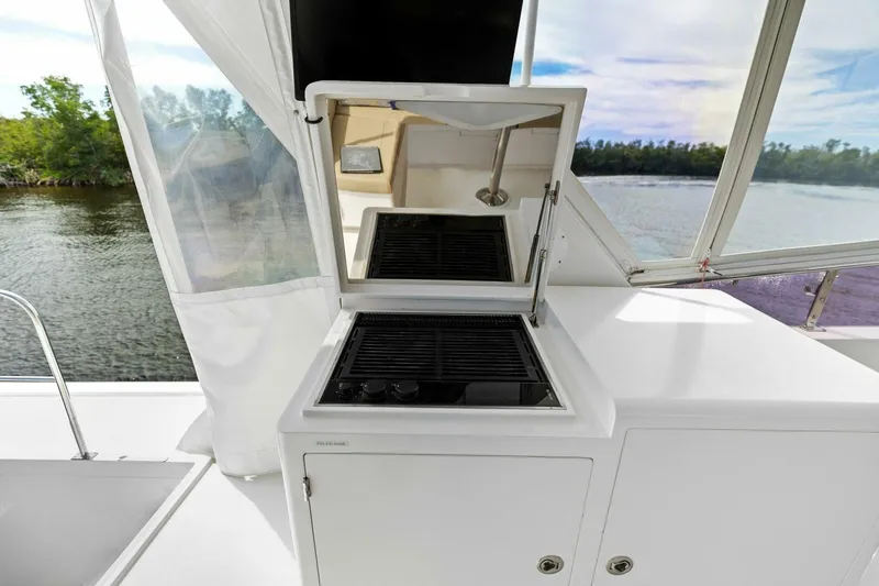 Slide: The Image of Boat deck with built-in grill overlooking scenic water and trees. - 18