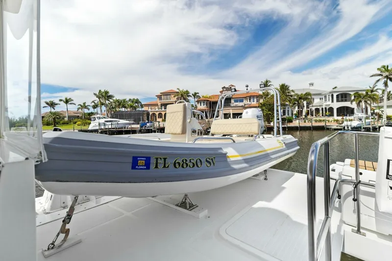 Slide: The Image of A small boat docked near luxury waterfront homes under a partly cloudy sky. - 19