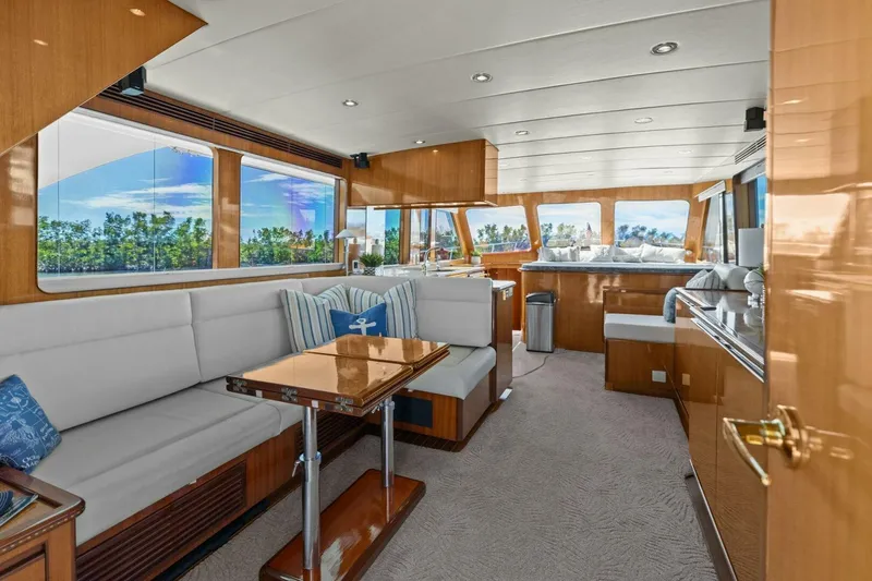 Slide: The Image of Luxurious yacht interior with plush seating, wooden accents, and large windows offering scenic views. - 21