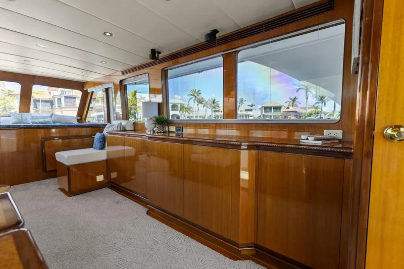 Slide: The Image of Luxurious yacht interior with wooden paneling and large windows, showcasing a serene waterfront view. - 22
