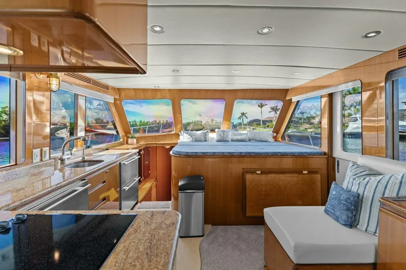 Slide: The Image of Luxurious yacht interior with kitchen, seating, and panoramic windows showcasing a scenic view. - 24