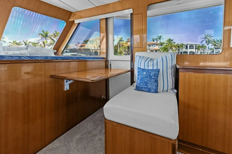 Slide: The Image of Luxurious yacht interior with wooden finish, cushioned seating, and scenic window views. - 25