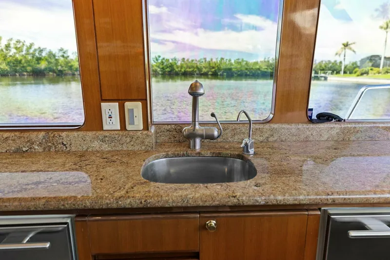 Slide: The Image of Luxurious boat kitchen with granite countertop and scenic water view through windows. - 31