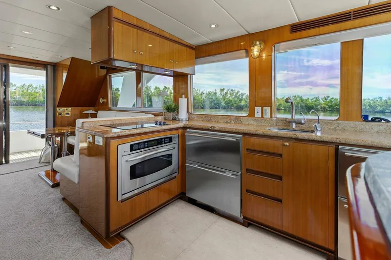 Slide: The Image of Luxurious yacht kitchen with modern appliances, wooden cabinetry, and scenic water views. - 32