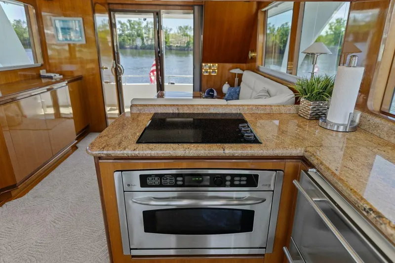 Slide: The Image of Luxurious yacht interior with modern kitchen, granite countertops, and scenic water view. - 34