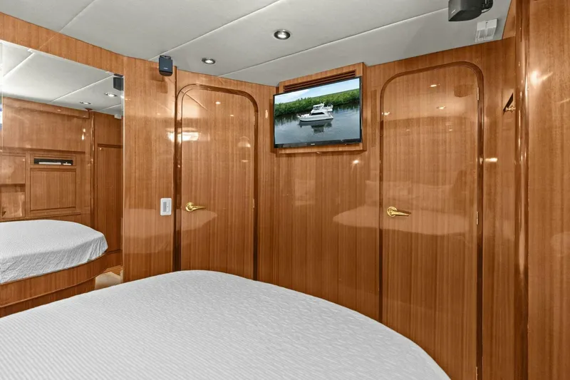 Slide: The Image of Luxurious yacht cabin with wood paneling, bed, and wall-mounted TV. - 41
