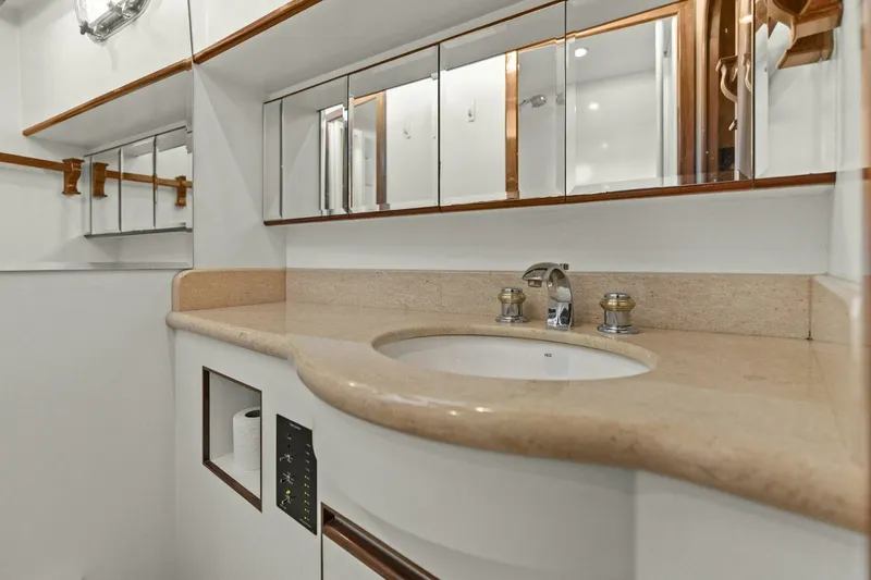 Slide: The Image of Modern bathroom vanity with beige countertop and mirrored cabinets. - 43