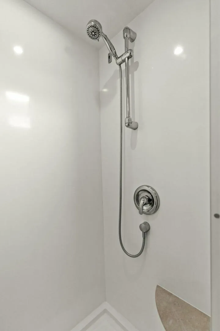 Slide: The Image of Modern shower with adjustable showerhead and sleek chrome fixtures in a white bathroom. - 45