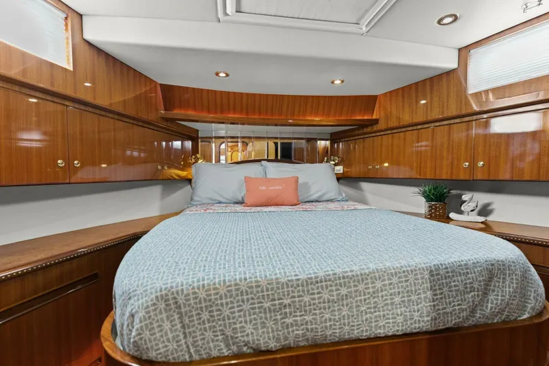 Slide: The Image of Luxurious yacht bedroom with wood paneling, cozy bedding, and ambient lighting. - 46