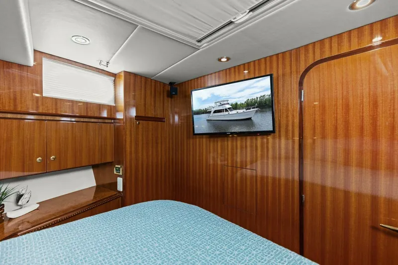 Slide: The Image of Luxurious yacht cabin with wood paneling and wall-mounted TV. - 47