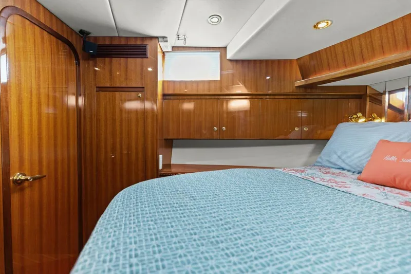 Slide: The Image of Luxurious yacht cabin with wooden paneling and a cozy bed. - 49