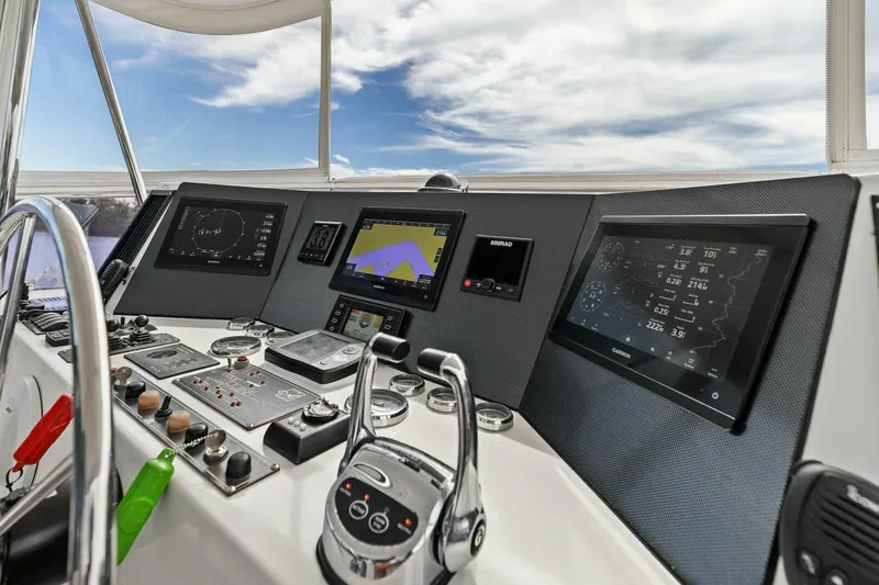 Slide: The Image of Boat cockpit with navigation screens and controls under a partly cloudy sky. - 7
