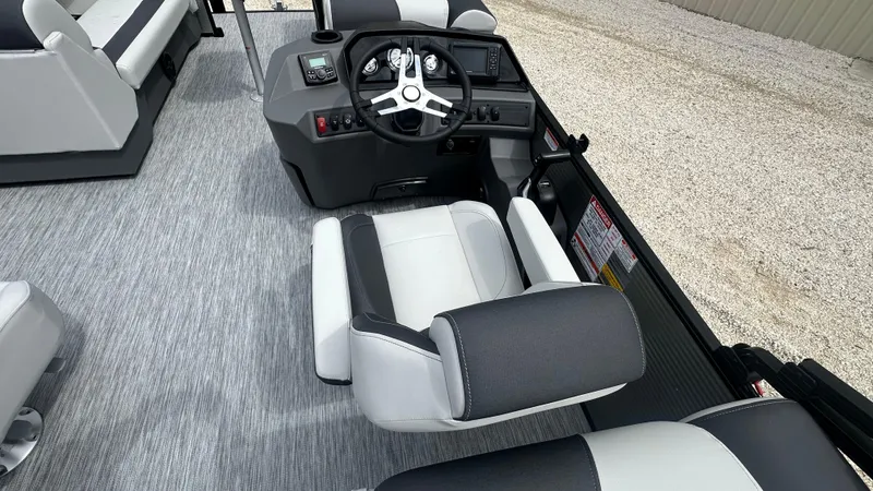 Slide: The Image of 2025 Bennington S Quad Bench 22 SSR boat interior with steering console and seating. - 10