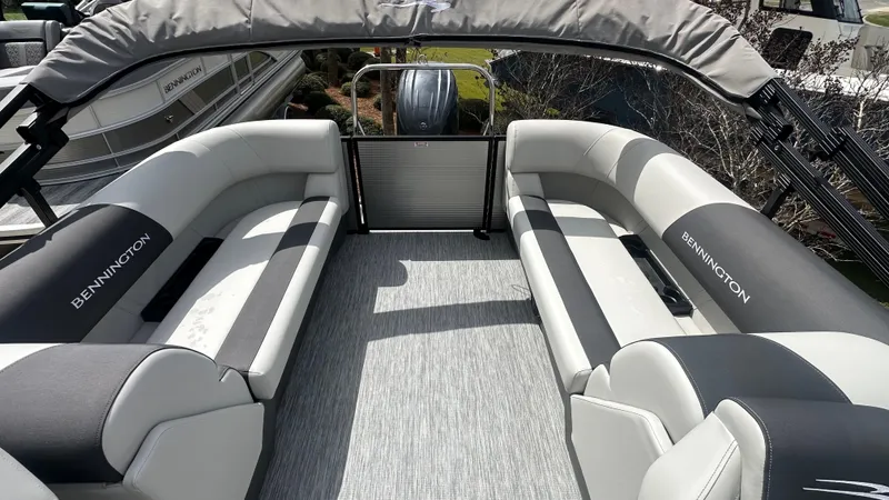 Slide: The Image of 2025 Bennington S Quad Bench 22 SSR interior with gray seating and flooring. - 5