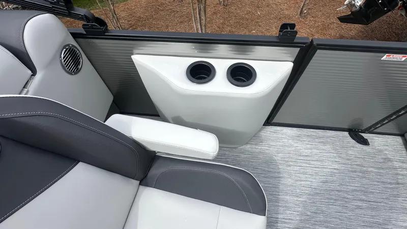 Slide: The Image of 2025 Bennington S Quad Bench 22 SSR interior with cup holders and seating. - 9