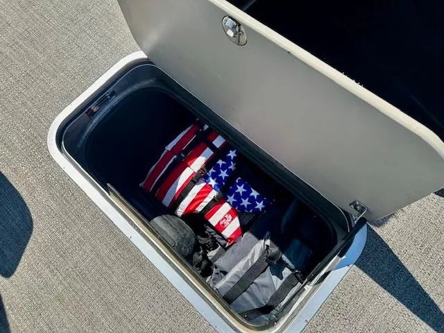 Slide: The Image of Storage compartment in 2023 Barletta C20UC boat with American flag life jacket. - 13
