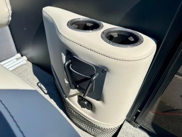 Slide: The Image of 2023 Barletta C20UC boat interior with dual cup holders and beige upholstery. - 15