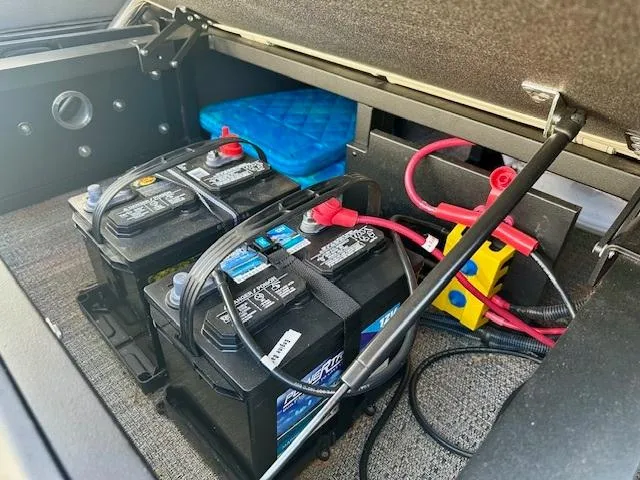 Slide: The Image of 2023 Barletta C20UC boat battery compartment with dual batteries and wiring. - 19