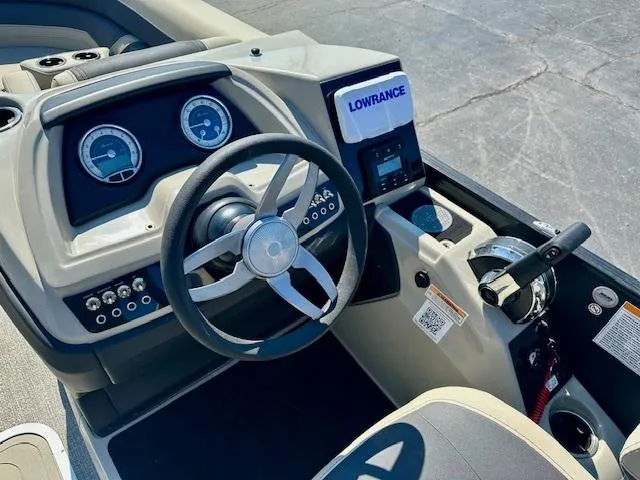 Slide: The Image of 2023 Barletta C20UC boat dashboard with steering wheel and Lowrance navigation system. - 6