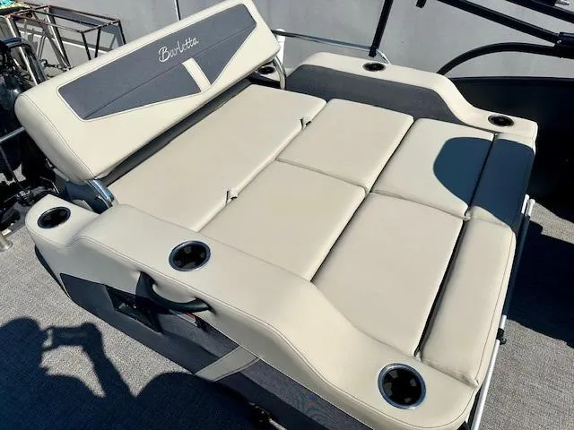 Slide: The Image of 2023 Barletta C20UC boat seating with cup holders, beige upholstery, and modern design. - 7