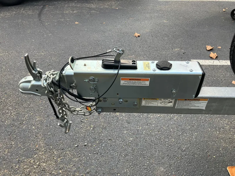 Slide: The Image of Trailer hitch with safety chains on asphalt, Cape Islander 22, 2003 model. - 4