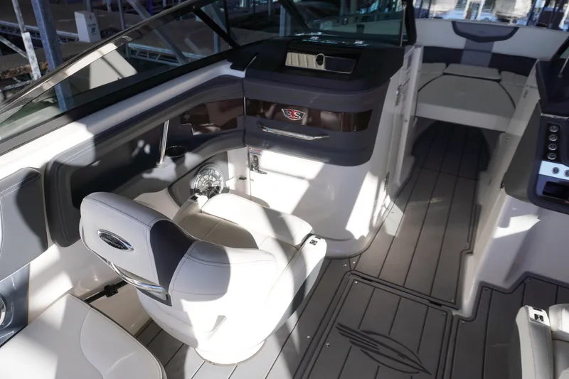 Slide: The Image of 2022 Chaparral 287 SSX boat interior with modern seating and sleek design. - 12