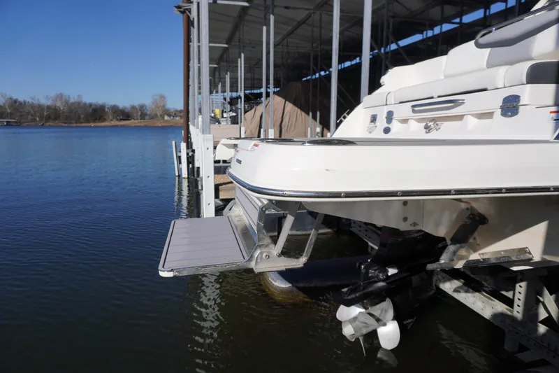 Slide: The Image of 2022 Chaparral 287 SSX boat docked, rear view with swim platform extended. - 5
