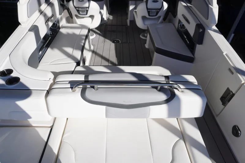 Slide: The Image of 2022 Chaparral 287 SSX boat interior with white seating and modern design. - 7