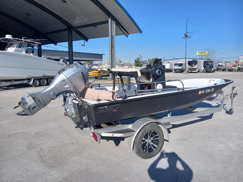Slide: The Image of 1980 Boston Whaler 15 Montauk dashboard with Garmin navigation system and steering wheel. - 10