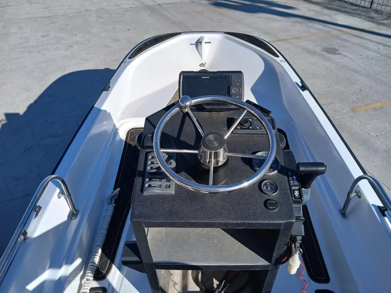 Slide: The Image of 1980 Boston Whaler 15 Montauk boat on trailer, parked outdoors under a canopy. - 5