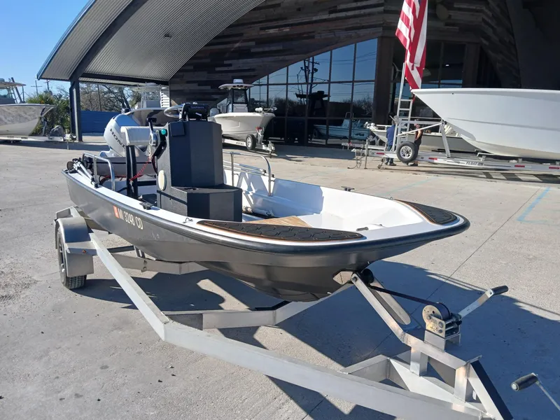 Slide: The Image of 1980 Boston Whaler 15 Montauk boat interior with wooden deck and black accents. - 7