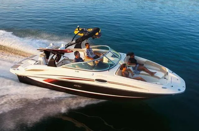 Slide: The Image of 2012 Sea Ray 260 Sundeck cruising on calm water with passengers enjoying the ride. - 1