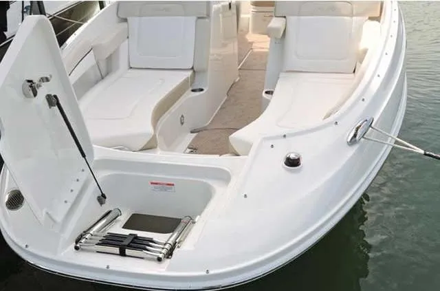 Slide: The Image of 2012 Sea Ray 260 Sundeck boat with open bow seating and swim ladder. - 8
