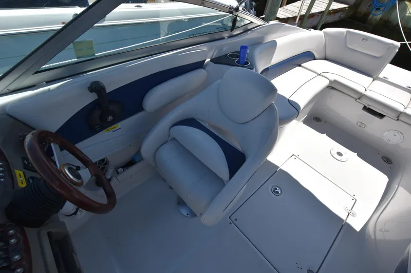 Slide: The Image of 2011 Crownline 265 SS boat interior with steering wheel and seating area. - 11