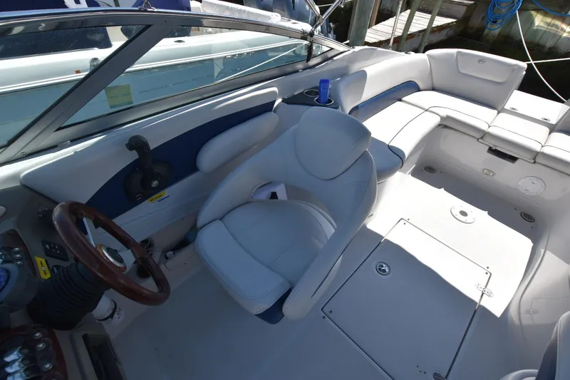 Slide: The Image of 2011 Crownline 265 SS boat interior with steering wheel and seating area. - 13