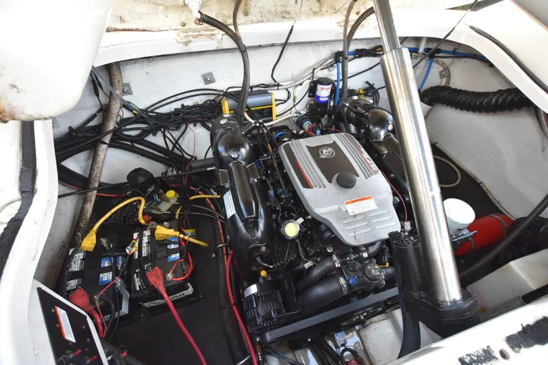 Slide: The Image of Engine compartment of a 2011 Crownline 265 SS boat, featuring wiring and components. - 14