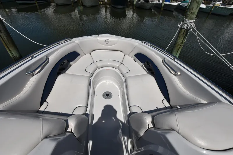 Slide: The Image of 2011 Crownline 265 SS boat interior with gray seating, docked at marina. - 4