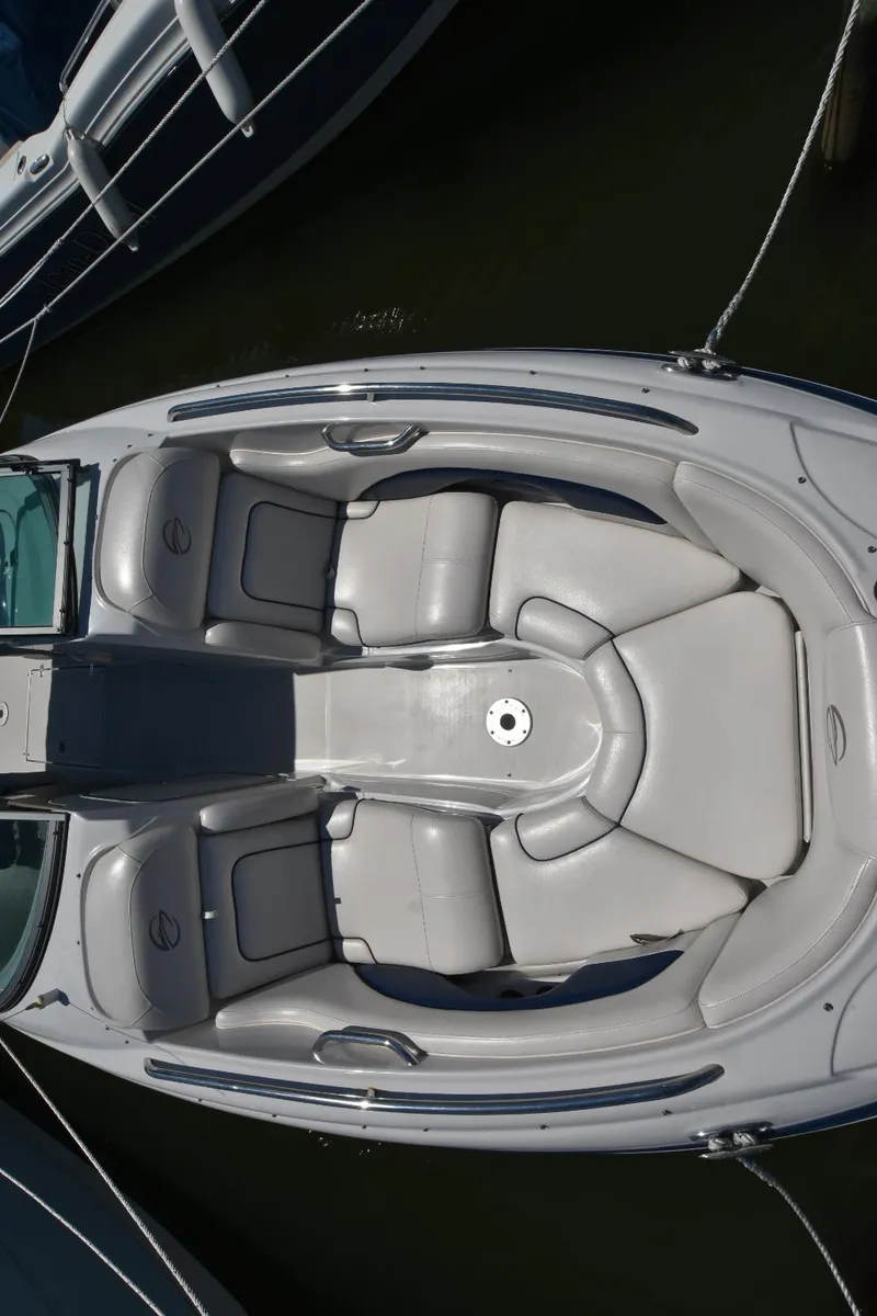 Slide: The Image of 2011 Crownline 265 SS boat with spacious seating, docked in water. - 5